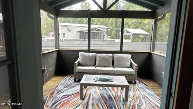 sunroom / solarium featuring plenty of natural light and vaulted ceiling