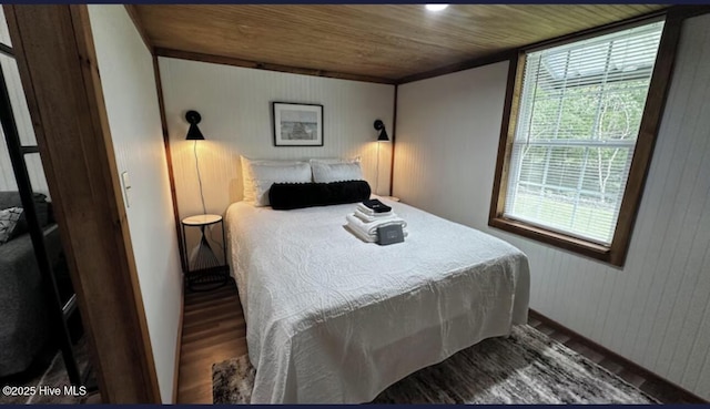 bedroom featuring wooden ceiling, wood walls, and wood finished floors