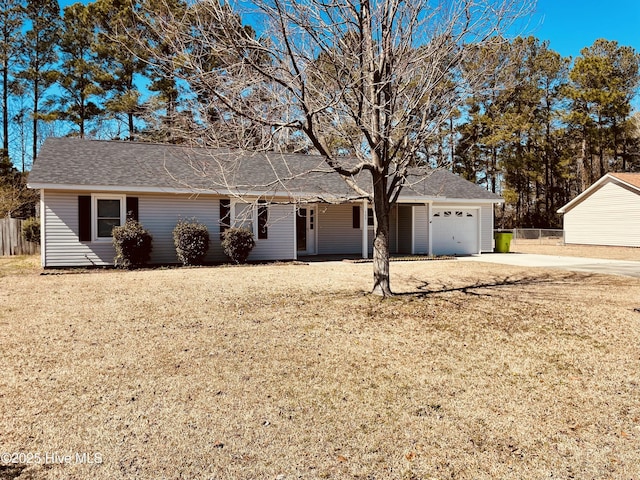 ranch-style house with driveway, a garage, fence, and a front lawn