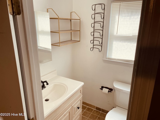 bathroom featuring toilet, vanity, and tile patterned floors