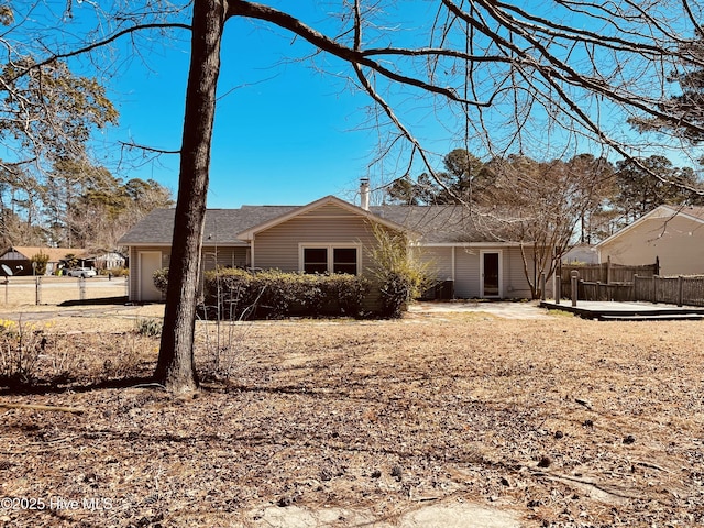 exterior space featuring a garage and fence