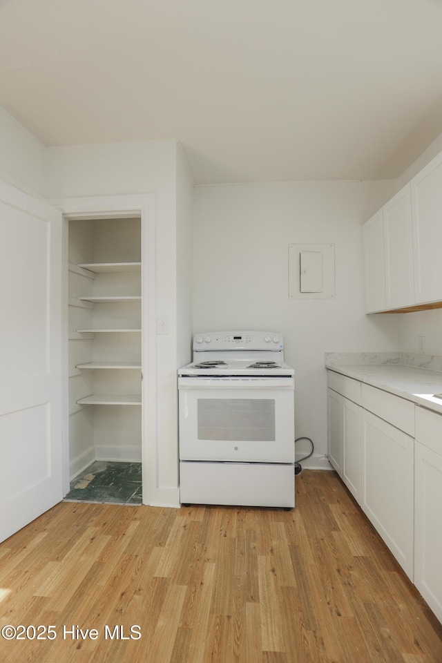 kitchen with light wood-style flooring, white cabinetry, light countertops, and white range with electric cooktop