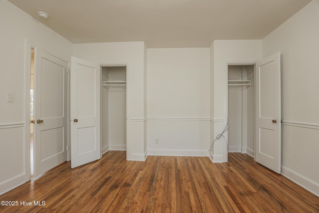 unfurnished bedroom with baseboards and wood finished floors