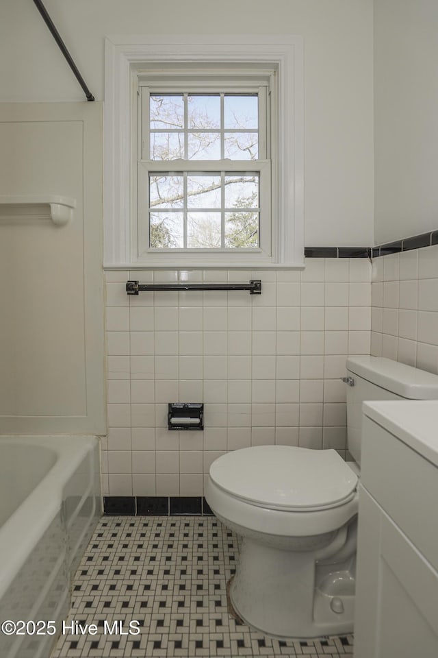 full bathroom with a shower, a tub to relax in, vanity, and toilet