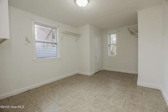 spacious closet with light tile patterned floors