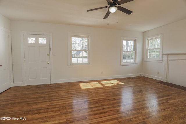 foyer entrance with ceiling fan, baseboards, and wood finished floors