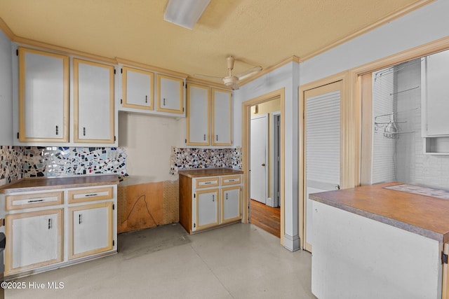 kitchen featuring decorative backsplash and concrete flooring