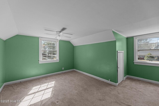 bonus room featuring carpet, vaulted ceiling, baseboards, and ceiling fan