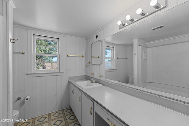 full bathroom with visible vents, vanity, toilet, and tile patterned floors