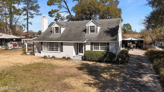 cape cod home with roof with shingles, a chimney, a front lawn, and brick siding