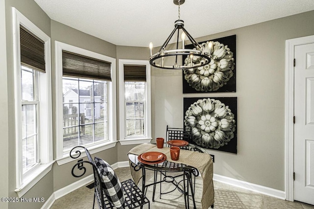 dining space with a chandelier and baseboards