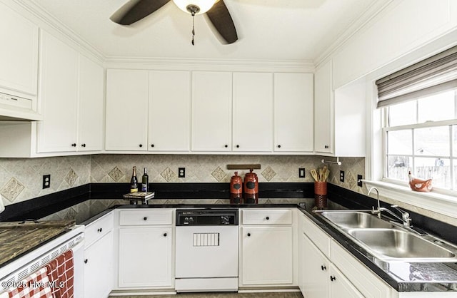 kitchen featuring white appliances, white cabinets, a sink, and backsplash