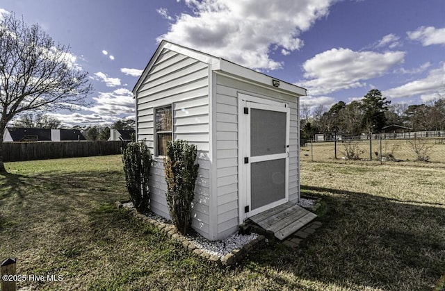 view of shed featuring fence