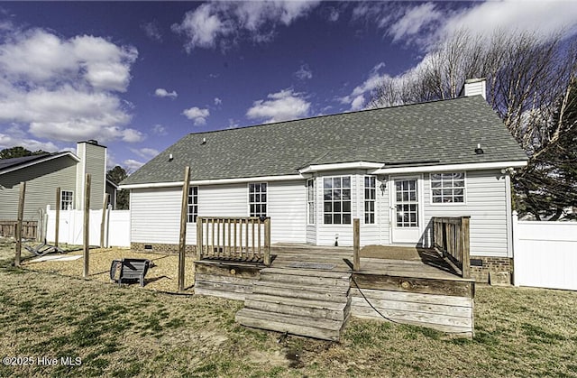 rear view of property featuring a shingled roof, a lawn, crawl space, fence, and a wooden deck