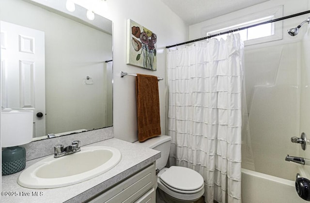 full bath featuring toilet, shower / bath combo, and vanity