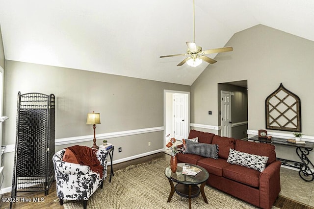 living room with high vaulted ceiling, ceiling fan, baseboards, and wood finished floors