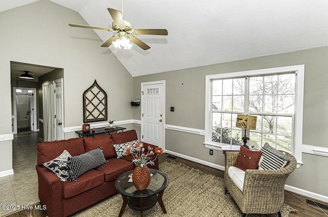 tiled living area featuring high vaulted ceiling, baseboards, visible vents, and ceiling fan