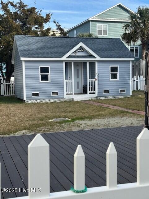 view of front facade with crawl space, covered porch, and a shingled roof