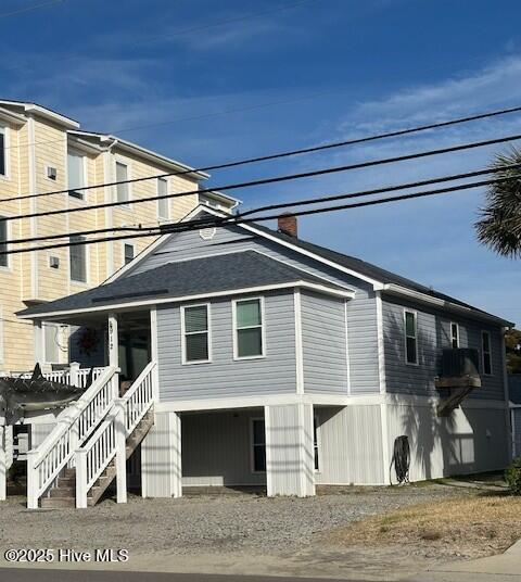 view of home's exterior featuring stairs