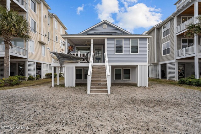 rear view of property featuring stairway