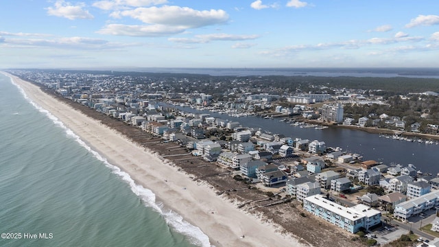 drone / aerial view with a beach view and a water view