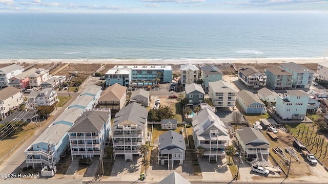 drone / aerial view featuring a residential view, a beach view, and a water view