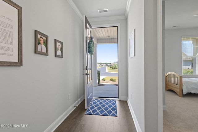 entryway with a wealth of natural light, visible vents, and baseboards