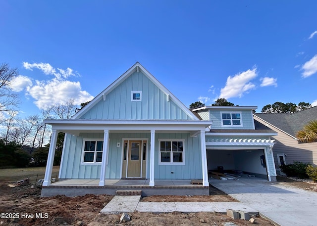 view of front of house with a porch, board and batten siding, concrete driveway, a shingled roof, and a garage