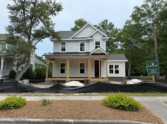 9118 E Lake Rd, Calabash, NC 28467 - view of front of house featuring covered porch, a standing seam roof, and metal roof