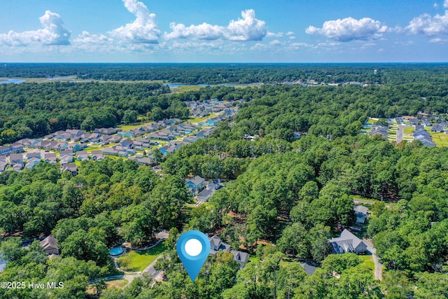 bird's eye view featuring a wooded view and a residential view