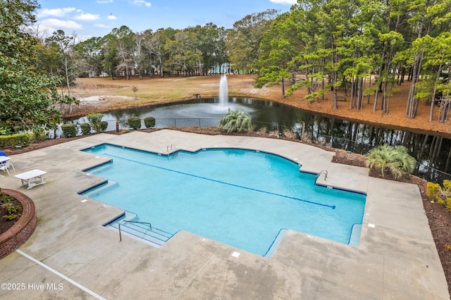 9118 E Lake Rd, Calabash, NC 28467 - community pool with view of wooded area, a patio, and a water view