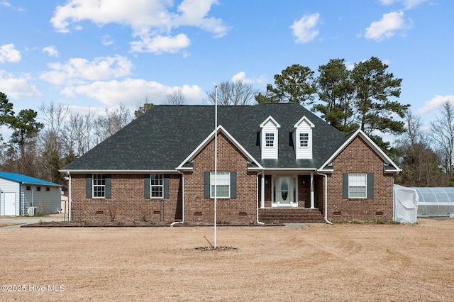 view of front of property with brick siding, an exterior structure, crawl space, central AC, and an outdoor structure