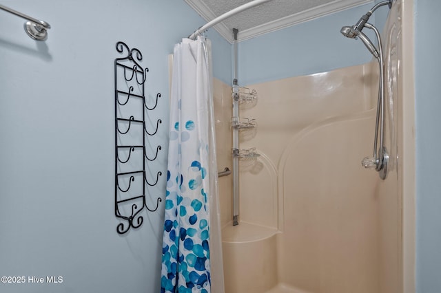 full bathroom with ornamental molding, a textured ceiling, and a shower with shower curtain