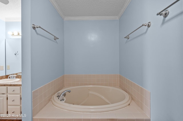 bathroom with a textured ceiling, ornamental molding, a bath, and vanity