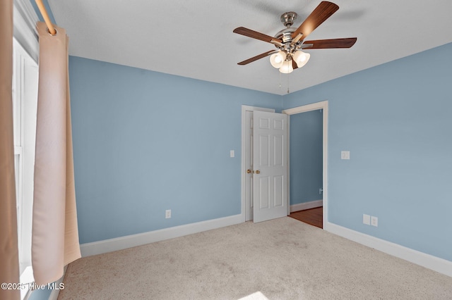 unfurnished bedroom featuring ceiling fan, baseboards, and carpet flooring