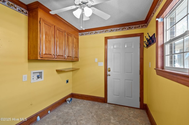 laundry area with a healthy amount of sunlight, hookup for an electric dryer, cabinet space, and a textured ceiling