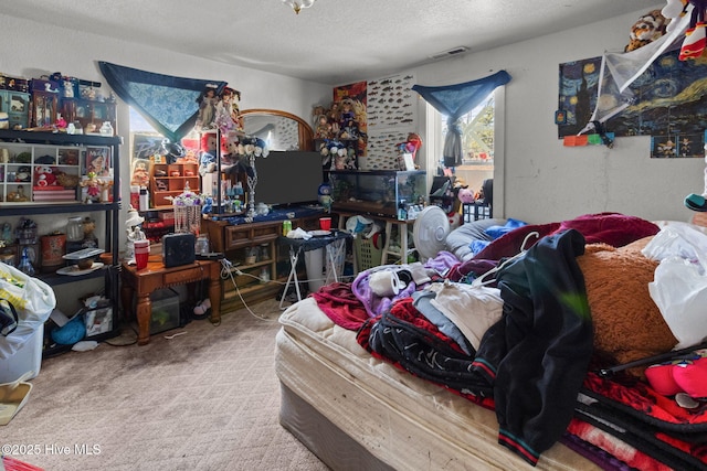 carpeted bedroom with a textured ceiling and visible vents