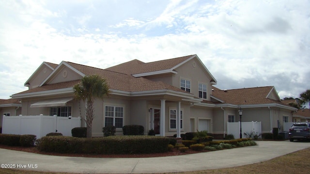 view of property exterior with fence and stucco siding