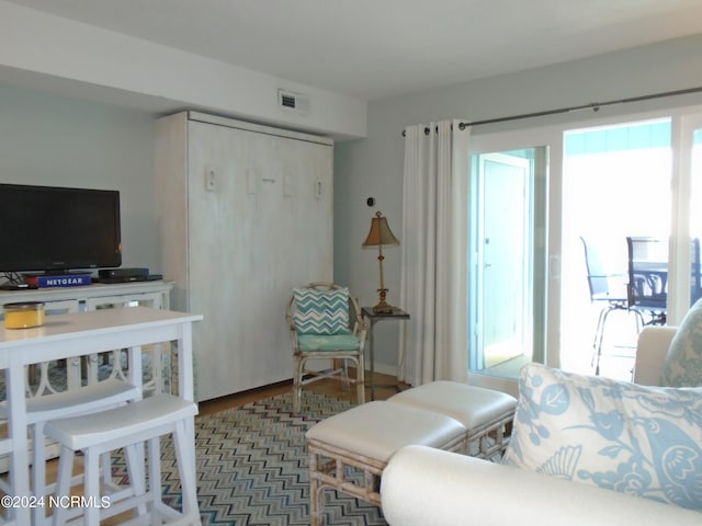 bedroom featuring multiple windows, wood finished floors, and visible vents