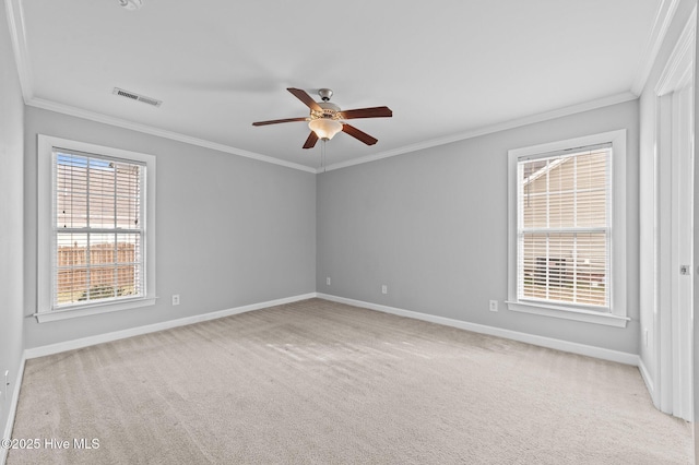 carpeted empty room featuring ornamental molding, visible vents, baseboards, and a ceiling fan