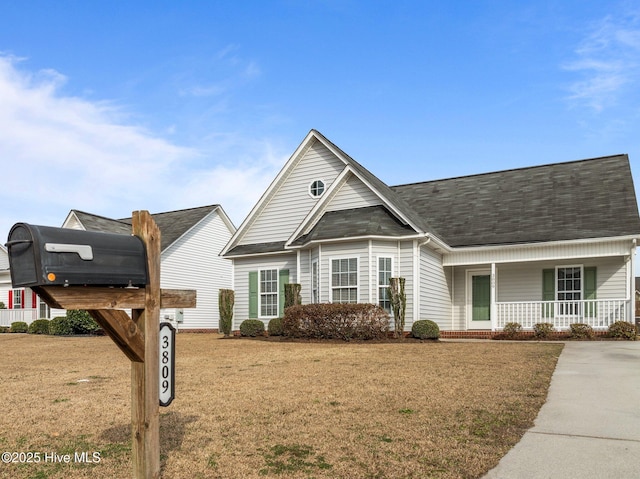 view of front of house with a front yard and covered porch