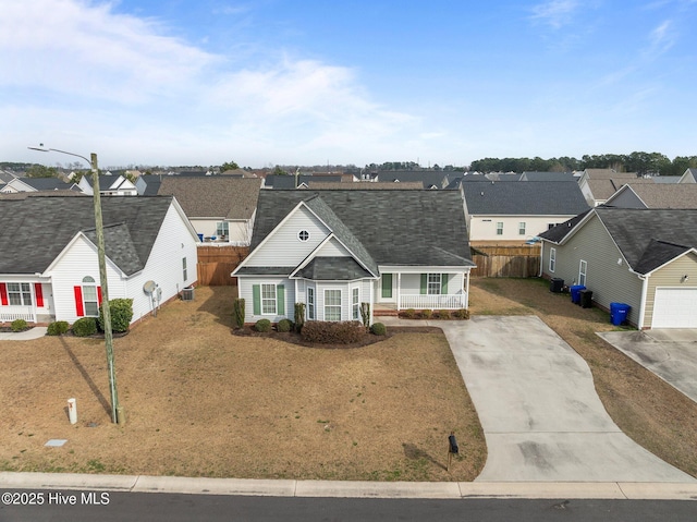 view of front of property featuring covered porch, a residential view, and fence