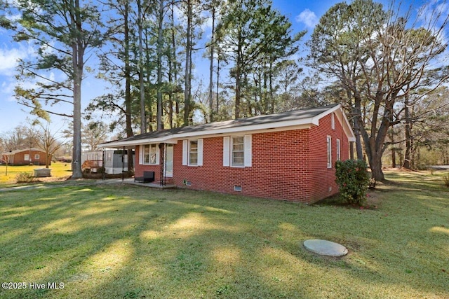 exterior space featuring a front yard, brick siding, and crawl space