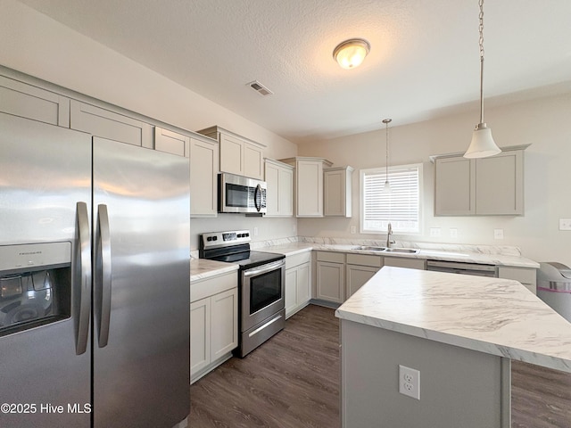 kitchen with visible vents, dark wood-type flooring, a sink, appliances with stainless steel finishes, and light countertops