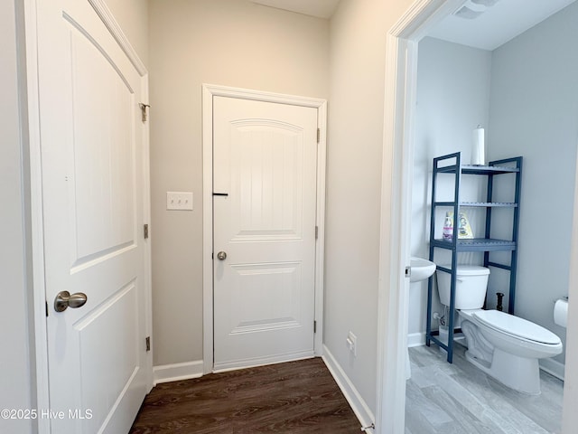 interior space featuring baseboards and wood finished floors