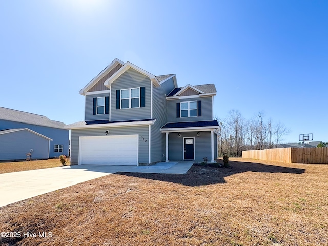 traditional home featuring an attached garage, fence, board and batten siding, and driveway