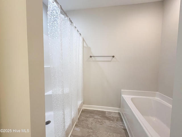 full bathroom with curtained shower, a bath, and baseboards