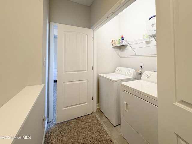 clothes washing area with washing machine and clothes dryer and laundry area
