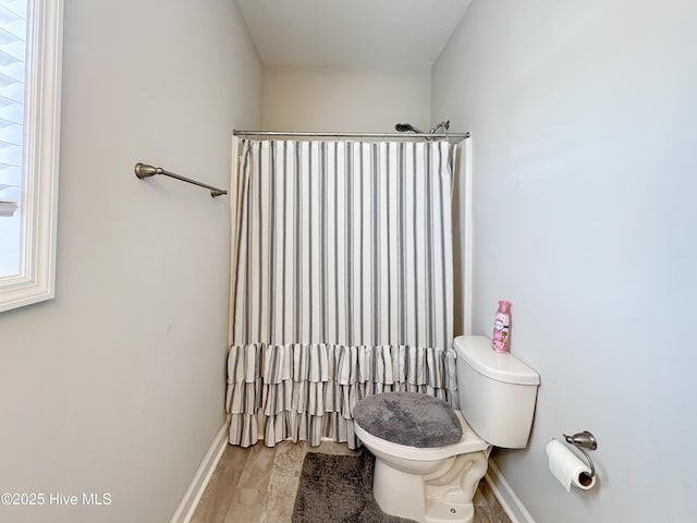 full bath featuring baseboards, toilet, and wood finished floors