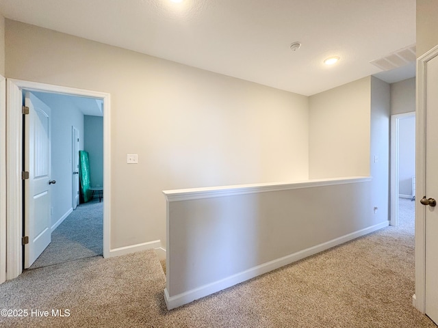 corridor featuring an upstairs landing, carpet, and baseboards